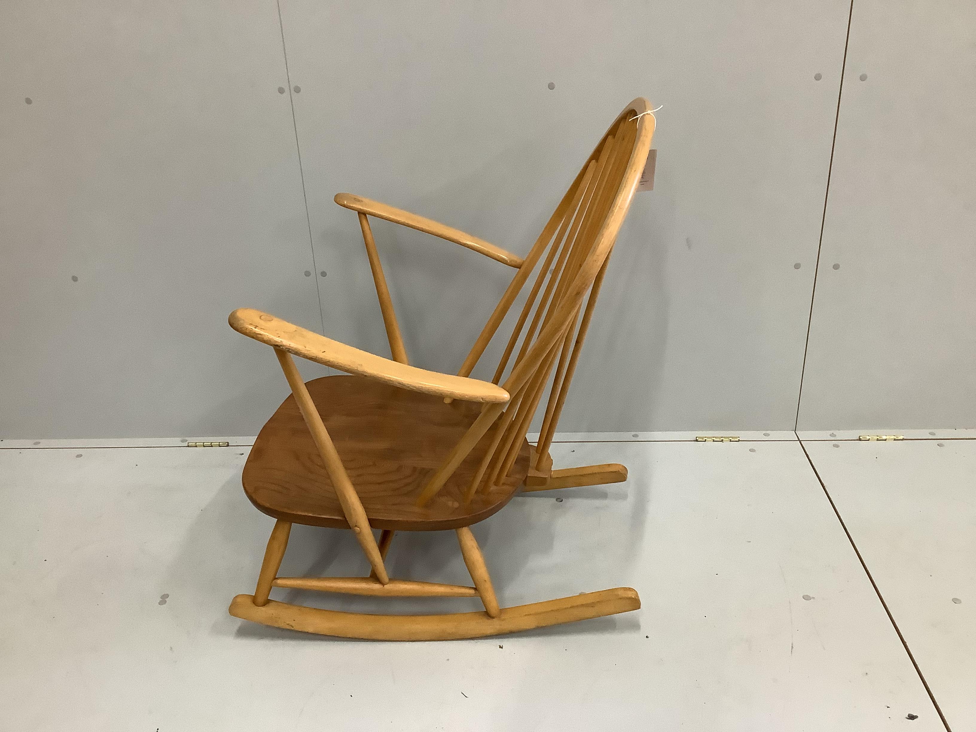 An Ercol elm and beech comb back rocking armchair, width 73cm, depth 78cm, height 95cm